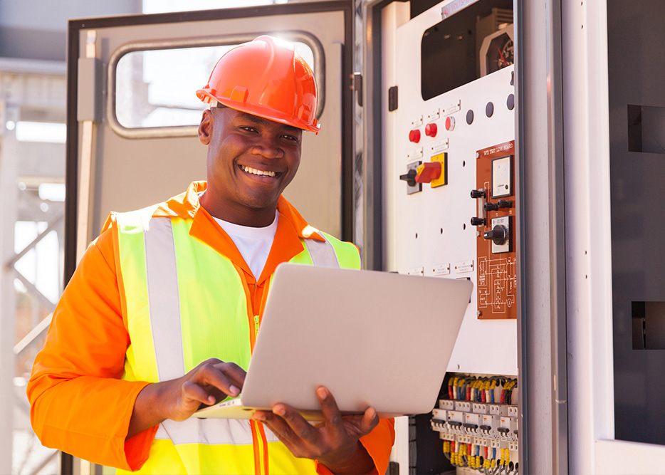 Male construction worker with laptop